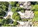 Overhead perspective of luxury homes showcasing mature trees, manicured lawns, and ample parking at 20011 Bragg, Chapel Hill, NC 27517