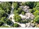 Stunning aerial view of a sprawling luxury home with mature landscaping and multiple driveways at 20011 Bragg, Chapel Hill, NC 27517