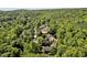 Scenic aerial shot of homes surrounded by a dense forest, showcasing a private and peaceful community at 20011 Bragg, Chapel Hill, NC 27517