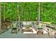 Cozy back deck featuring patio furniture, green accents and surrounded by a beautiful forest at 20011 Bragg, Chapel Hill, NC 27517