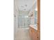 Bright bathroom with a shower-tub combo, updated vanity, and a large mirror at 20011 Bragg, Chapel Hill, NC 27517
