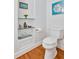Elegant powder room featuring hardwood floors, built-in shelving, and a modern toilet at 20011 Bragg, Chapel Hill, NC 27517