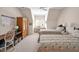 Cozy bedroom with twin beds, a built-in desk area, and a vintage-style armoire for ample storage at 20011 Bragg, Chapel Hill, NC 27517