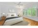 Modern bedroom with a ceiling fan, wood floors, and a large window overlooking the scenic yard at 20011 Bragg, Chapel Hill, NC 27517