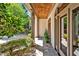 Inviting covered porch with stone flooring, wood paneled ceiling, and views of lush landscaping and beautiful gardens at 20011 Bragg, Chapel Hill, NC 27517