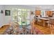 Bright dining area with a glass table, wood floors, and natural light from the beautiful outdoor view at 20011 Bragg, Chapel Hill, NC 27517