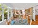 Bright dining area with glass table, hardwood floors, and an open flow into a spacious kitchen at 20011 Bragg, Chapel Hill, NC 27517
