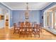 Dining room with chandelier, hardwood floors, and a view of the property's lush landscaping at 20011 Bragg, Chapel Hill, NC 27517