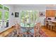 Dining room featuring a glass table for six, an area rug and natural lighting through the windows at 20011 Bragg, Chapel Hill, NC 27517