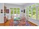 Dining room with a glass-top table, seating for six, an area rug and backyard views at 20011 Bragg, Chapel Hill, NC 27517