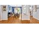 Formal dining room with elegant chandelier, wood floors, and an open floor plan into the foyer at 20011 Bragg, Chapel Hill, NC 27517