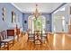 Formal dining room featuring wainscotting, a chandelier, wood floors, and French doors to the patio at 20011 Bragg, Chapel Hill, NC 27517