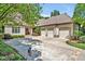 Traditional home with a three-car garage, mature landscaping, and a well-manicured lawn at 20011 Bragg, Chapel Hill, NC 27517