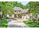 Traditional home with a three-car garage, mature landscaping, and a well-manicured lawn at 20011 Bragg, Chapel Hill, NC 27517