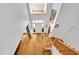Aerial view of foyer showcasing hardwood floors, staircase with decorative railings, and plenty of natural light at 20011 Bragg, Chapel Hill, NC 27517