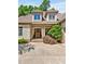 Charming home with a well-manicured lawn, mature landscaping, and an inviting entrance with a beautiful wood door at 20011 Bragg, Chapel Hill, NC 27517