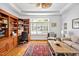 Home office space with custom wood built-ins, a large window, and hardwood flooring at 20011 Bragg, Chapel Hill, NC 27517