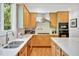 Modern kitchen featuring stainless steel appliances, an island, and light-colored wooden cabinets at 20011 Bragg, Chapel Hill, NC 27517