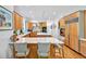 Bright open kitchen with stainless steel appliances, center island, and light-colored wood cabinets at 20011 Bragg, Chapel Hill, NC 27517