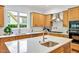 Large kitchen featuring granite counters, stainless steel appliances, and island with sink at 20011 Bragg, Chapel Hill, NC 27517