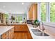 Bright kitchen features stainless steel sink, white countertops and light-colored wooden cabinetry at 20011 Bragg, Chapel Hill, NC 27517