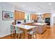 Open kitchen features large island with white countertops, seating, and light-colored cabinets at 20011 Bragg, Chapel Hill, NC 27517