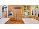 Gourmet kitchen with stainless steel oven and refrigerator, light colored cabinets and white countertops at 20011 Bragg, Chapel Hill, NC 27517
