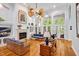 Spacious living room featuring a fireplace, large windows, and hardwood floors at 20011 Bragg, Chapel Hill, NC 27517