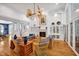 Elegant living room with a fireplace, large windows, and beautiful hardwood floors at 20011 Bragg, Chapel Hill, NC 27517