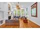 Bright living room with a fireplace, large windows, and hardwood floors at 20011 Bragg, Chapel Hill, NC 27517