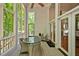 Relax in this sunroom with a marble table, wicker chairs, and views of nature at 20011 Bragg, Chapel Hill, NC 27517