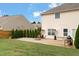 A stone patio features a fire pit in a large backyard, complete with lawn and bordering privacy fence at 203 Green Pasture Rd, Mebane, NC 27302