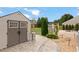 Landscaped backyard featuring a shed, patio heater, outdoor seating, and lush greenery at 203 Green Pasture Rd, Mebane, NC 27302