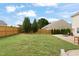 Large grassy backyard with a patio, fire pit, and privacy fence, perfect for outdoor entertaining at 203 Green Pasture Rd, Mebane, NC 27302