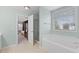 Light bathroom with tub, glass shower, tile flooring and natural light at 203 Green Pasture Rd, Mebane, NC 27302