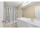 Functional bathroom features a vanity with a sink and a shower with black and white curtain at 203 Green Pasture Rd, Mebane, NC 27302