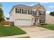 Two-story home features a manicured lawn, two-car garage, and stone and siding accents at 203 Green Pasture Rd, Mebane, NC 27302