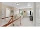 Inviting hallway with natural light, complemented by elegant staircase and a comfortable seating area at 203 Green Pasture Rd, Mebane, NC 27302