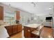 Kitchen with bar seating, wood cabinets, stainless appliances, with living room in the background at 203 Green Pasture Rd, Mebane, NC 27302