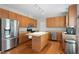 Spacious kitchen with stainless steel appliances, ample wood cabinetry, and a center island at 203 Green Pasture Rd, Mebane, NC 27302