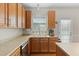 Functional kitchen with stainless steel dishwasher, and wood cabinets under a sunny window at 203 Green Pasture Rd, Mebane, NC 27302