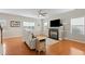 Cozy living room with a fireplace, wood floors, and modern ceiling fan at 203 Green Pasture Rd, Mebane, NC 27302