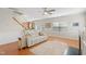 Cozy living room featuring hardwood floors, a ceiling fan, and a comfortable white leather sofa at 203 Green Pasture Rd, Mebane, NC 27302
