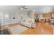 Bright and open-concept living room flows into the kitchen with hardwood floors and a white leather sofa at 203 Green Pasture Rd, Mebane, NC 27302