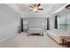 Large bedroom boasts a sitting area, ceiling fan and multiple bright windows at 203 Green Pasture Rd, Mebane, NC 27302