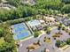 An aerial view shows neighborhood amenities, including a clubhouse, tennis courts, and a large pool with seating at 2049 Rainy Lake St, Wake Forest, NC 27587
