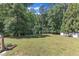 Large backyard featuring lush green lawn and mature trees at 2049 Rainy Lake St, Wake Forest, NC 27587