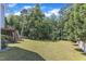 Spacious backyard featuring lush green lawn and mature trees at 2049 Rainy Lake St, Wake Forest, NC 27587