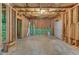 Unfinished basement features framing, concrete floor, and walkout access at 2049 Rainy Lake St, Wake Forest, NC 27587