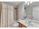 Cozy bathroom with shower-tub combination, vanity, and neutral tile at 2049 Rainy Lake St, Wake Forest, NC 27587